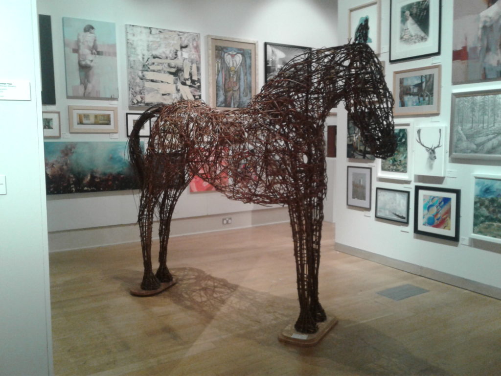 Full sized horse sculpture made out of woven willow branches.