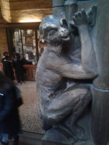 close up of monkey that climbs the arches of the Natural History Museum in London. Monkey looking at the camera, tail out of shot.